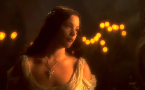 HD PC desktop wallpaper featuring a scene from The Lord of the Rings: The Fellowship of the Ring, showing a softly lit close-up of a female character in a medieval setting.