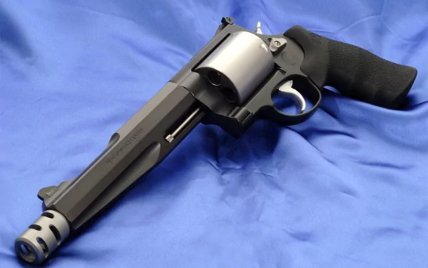 High-definition desktop wallpaper featuring a Smith & Wesson revolver with a black grip resting on a blue fabric background.