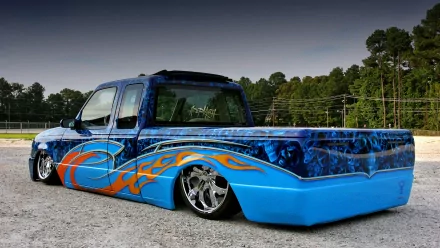 Custom lowered blue truck with flame graphics and chrome wheels, vehicle showcased as a 4K Ultra HD PC desktop wallpaper background.