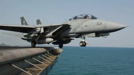 Military Grumman F-14 Tomcat launching from an aircraft carrier over the ocean — HD PC desktop wallpaper and background.