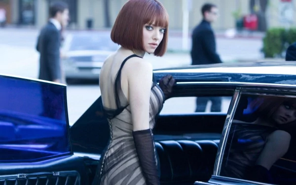 Cinematic still of a woman in a sheer evening dress and gloves stepping from a sleek car on a city street — from the movie In Time. HD PC desktop wallpaper/background.