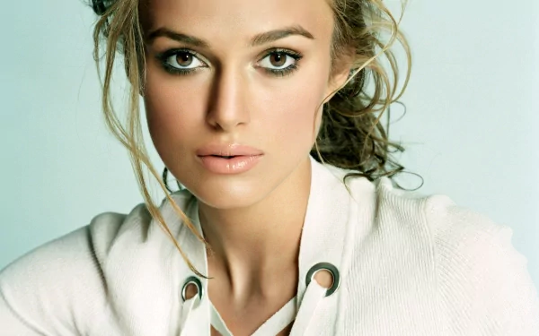 HD desktop wallpaper featuring actress Keira Knightley in a close-up shot with a soft background, highlighting her natural beauty and expressive eyes.