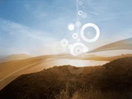 A scenic HD desktop wallpaper featuring a tranquil landscape with sunshine and artistic vector circles blending harmoniously into the sky above hills and a calm waterbody.