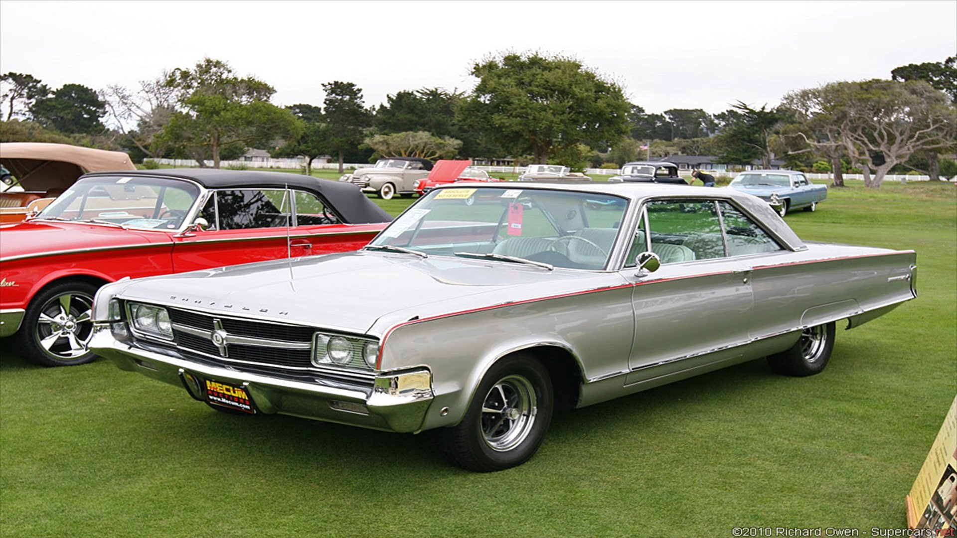 HD PC desktop wallpaper of a silver classic Chrysler vehicle on green grass at a vintage car show