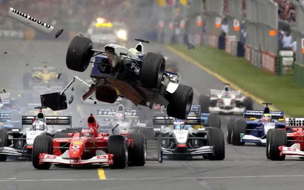 An intense Formula 1 race scene captures a car flipping in the air amidst a competitive field, highlighting the excitement and drama of F1 sports in a dynamic HD wallpaper.