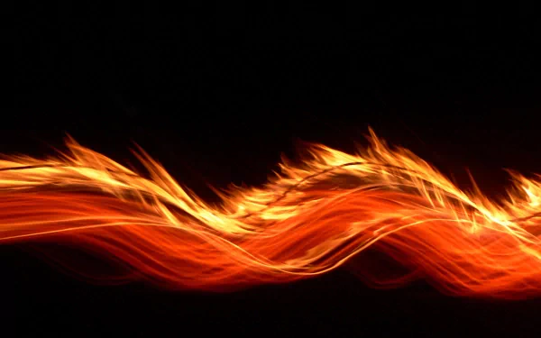 A vibrant, abstract display of swirling flames contrasts against a black background, creating a striking artistic wallpaper for HD PC desktops.