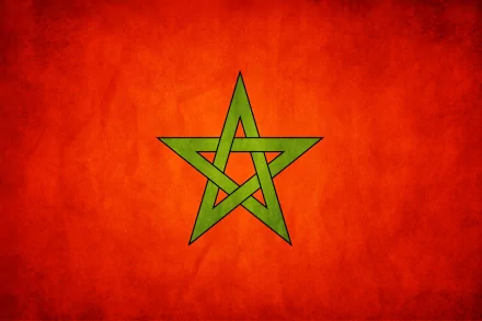 HD desktop wallpaper featuring the flag of Morocco, showcasing a vibrant red background with a central green pentagram. A striking visual representation of Moroccan identity.