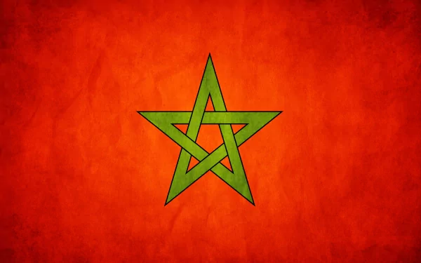 HD desktop wallpaper featuring the flag of Morocco, showcasing a vibrant red background with a central green pentagram. A striking visual representation of Moroccan identity.
