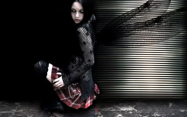 A dark, gothic HD desktop wallpaper featuring a figure with ethereal wings, dressed in a mesh top and plaid skirt, set against a striking, textured backdrop.