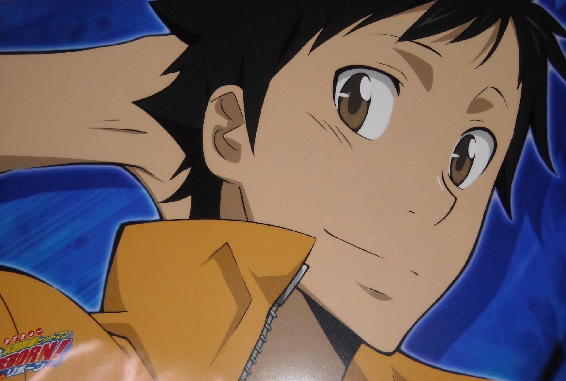 HD desktop wallpaper of Takeshi Yamamoto from Katekyō Hitman Reborn!, smiling close-up against a blue background in a yellow jacket.