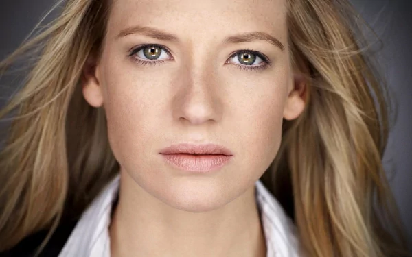 HD desktop wallpaper featuring a close-up of celebrity Anna Torv with natural makeup and flowing hair against a neutral background.