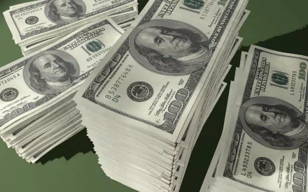 HD desktop wallpaper featuring stacks of man-made US dollar bills arranged on a green surface, emphasizing currency and wealth.