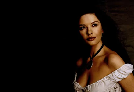 HD PC desktop wallpaper featuring celebrity Catherine Zeta-Jones with a dark background and soft lighting highlighting her face and shoulders.