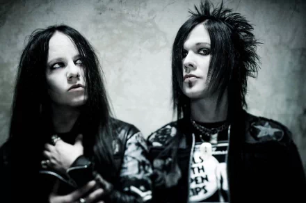 HD PC desktop wallpaper featuring two members of the band Murderdolls with dark, gothic makeup and attire, set against a muted, textured background.