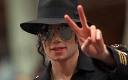 HD desktop wallpaper featuring Michael Jackson wearing a black hat, sunglasses, and showing a peace sign.