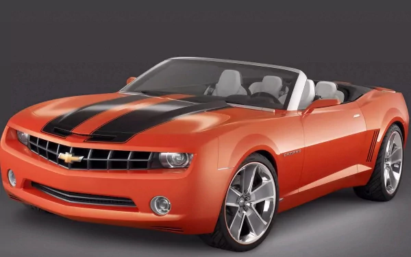 HD PC desktop wallpaper featuring a vibrant orange Chevrolet Camaro Convertible with black racing stripes against a dark background.