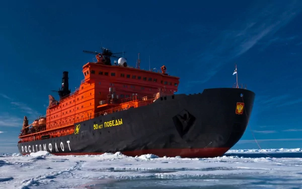 HD desktop wallpaper of a powerful icebreaker ship navigating through icy waters under a clear blue sky.