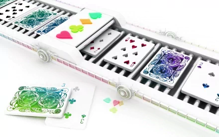 A vibrant desktop wallpaper featuring colorful playing cards cascading down a conveyor-like system, showcasing a creative and dynamic design in HD quality.