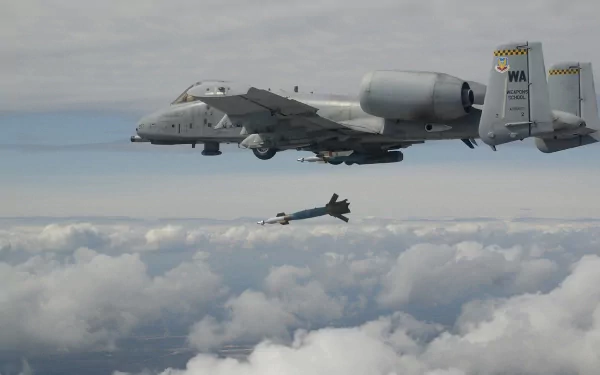 Fairchild Republic A-10 Thunderbolt II military aircraft releasing a missile over a cloudy sky, featured as an HD PC desktop wallpaper.
