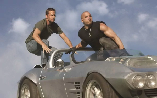 HD desktop wallpaper featuring Paul Walker as Brian O'Conner and Vin Diesel as Dominic Toretto from the movie Fast Five, both perched on a sleek car against a backdrop of a partly cloudy sky.