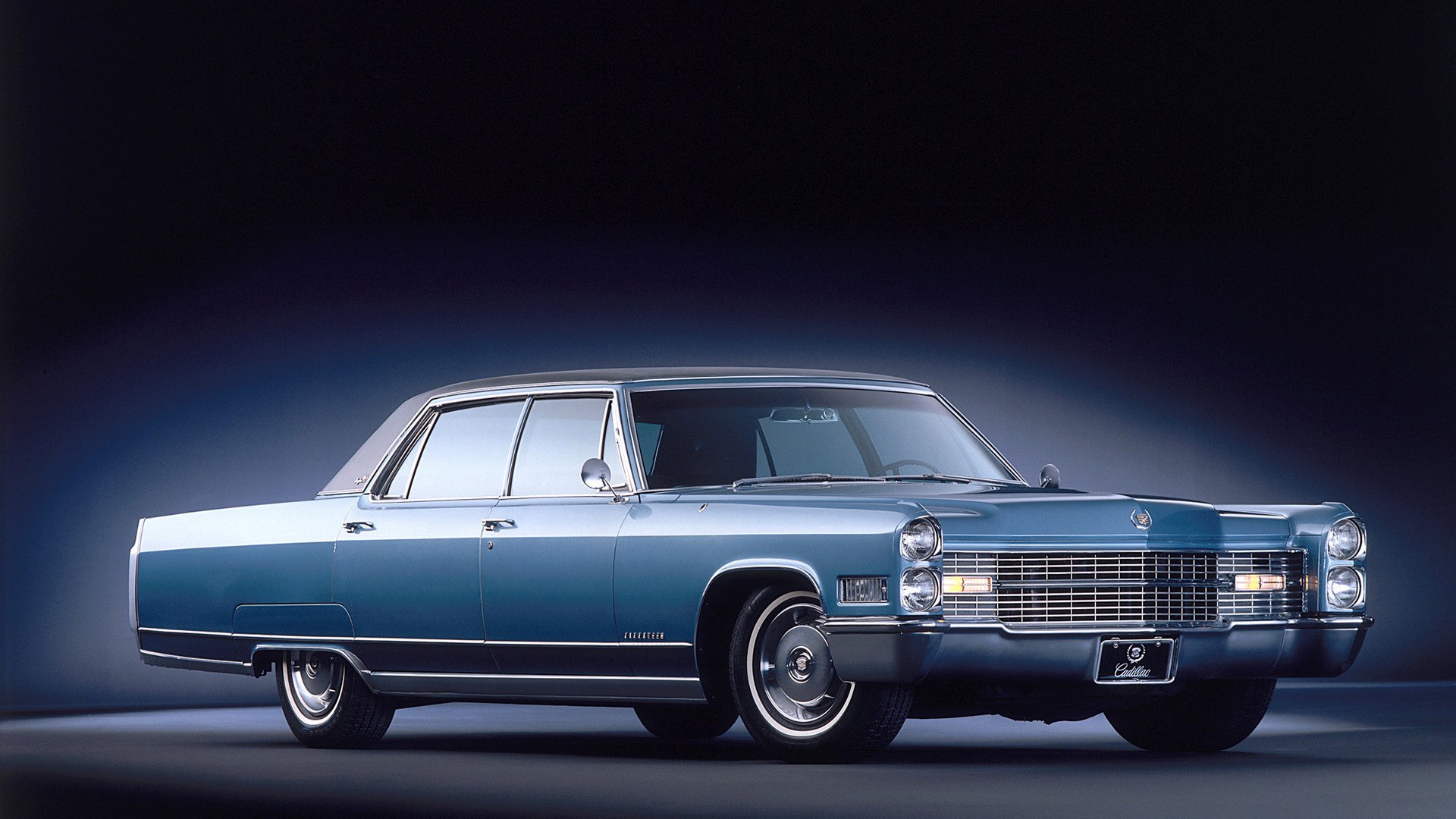 Classic blue full-size vehicle sedan in studio lighting on a dark gradient — HD PC desktop wallpaper background.