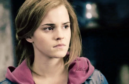 HD desktop wallpaper featuring a close-up of celebrity Emma Watson with a contemplative expression against a softly blurred background.