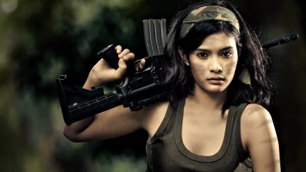 A strong woman stands confidently with a rifle, exuding determination. This HD desktop wallpaper captures the theme of Girls & Guns vividly.