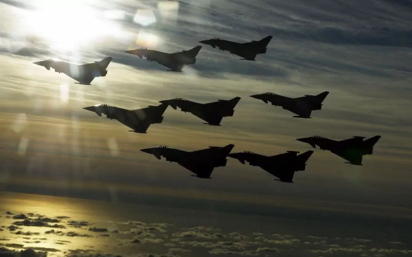 HD PC desktop wallpaper and background: silhouetted military jets in formation at sunset during an air show over cloud tops.