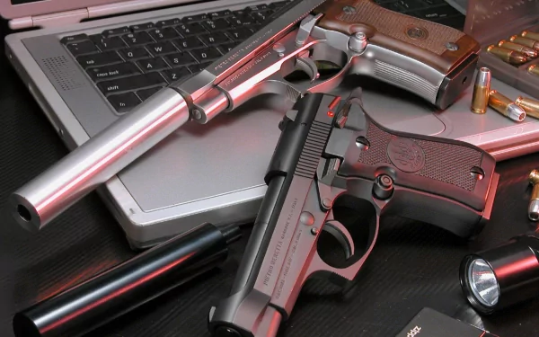 HD PC desktop wallpaper: man-made scene of Beretta pistols, suppressor, ammunition and a laptop keyboard.