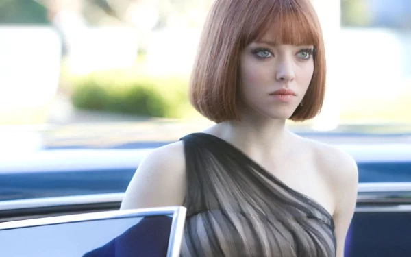 HD PC desktop wallpaper featuring Amanda Seyfried from the movie In Time, showcasing her with a short red hairstyle and a black one-shoulder dress.