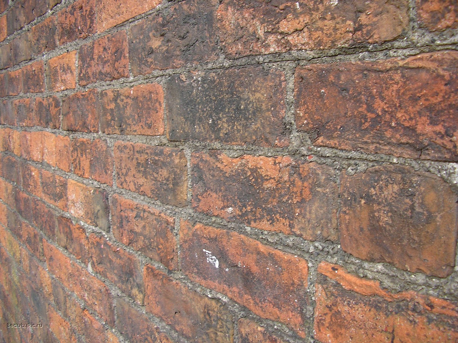 HD photography of a weathered red brick wall in close-up with textured diagonal perspective — PC desktop wallpaper background.