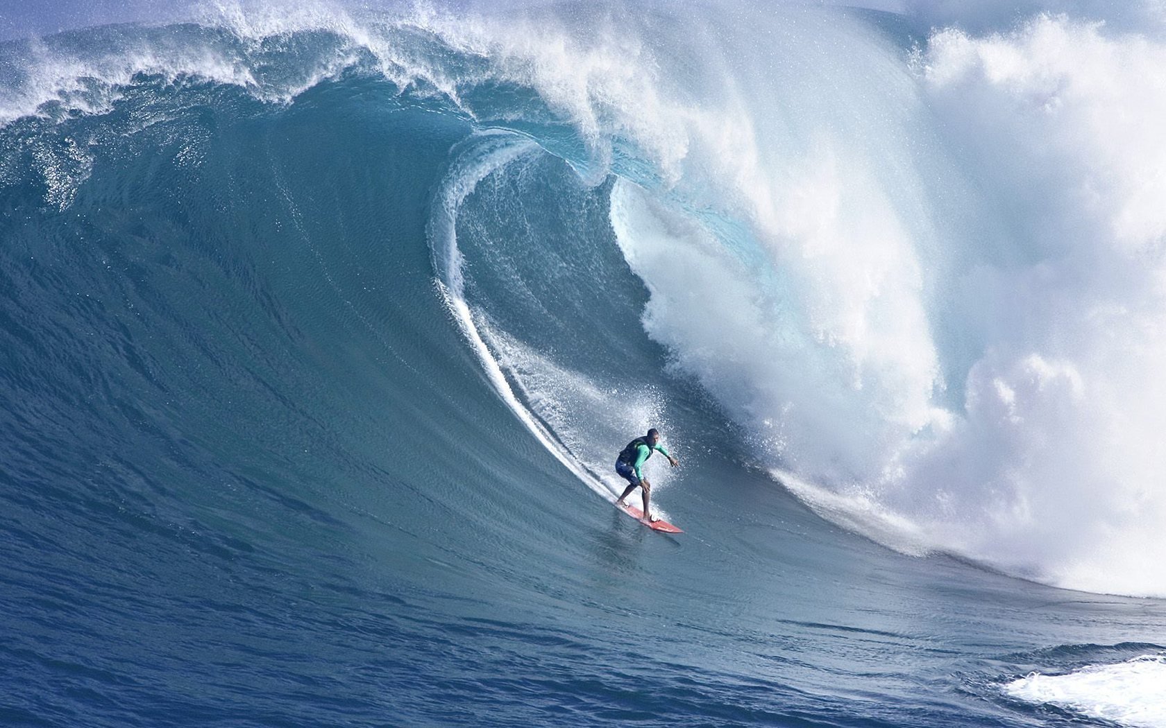 HD PC desktop wallpaper showcasing a surfer skillfully riding a massive ocean wave, capturing the thrill of surfing and dynamic sports action.