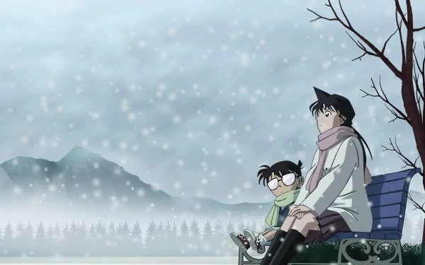 In a serene winter scene, Ran Mouri and Shinichi Kudo, alongside Conan Edogawa, sit on a bench amidst falling snow, capturing a moment of tranquility in the world of Detective Conan.