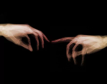 HD desktop wallpaper featuring two skeletal hands reaching towards each other against a dark, creepy background.
