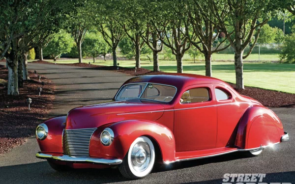 HD PC desktop wallpaper background: red classic Ford vehicle coupe with chrome wheels, glossy paint parked on a tree-lined road.