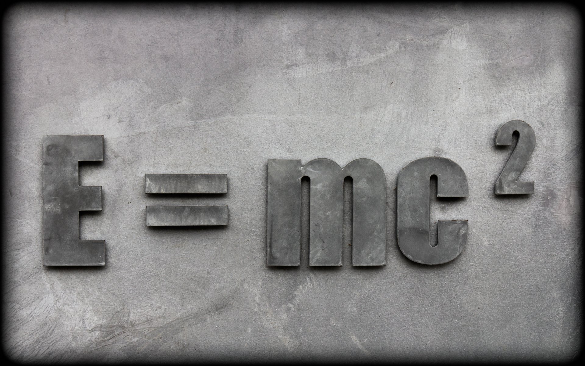 A textured gray background features the iconic equation E=mc², symbolizing the intersection of technology, physics, and chemistry in a striking HD desktop wallpaper.