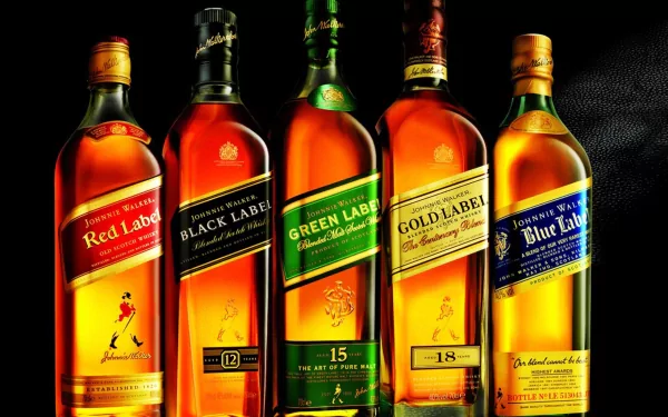 An HD wallpaper featuring a lineup of whisky bottles showcasing various labels, including Red, Black, Green, Gold, and Blue Label, against a sleek black background.