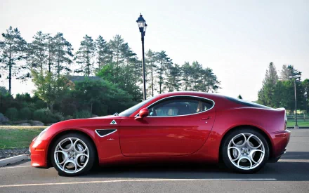 Red Alfa Romeo 8C Competizione parked by a tree-lined road under a lamppost — HD PC desktop wallpaper/background.