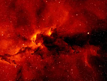 HD Sci-Fi wallpaper of a vibrant nebula, glowing with intense red and orange hues against a starry backdrop.