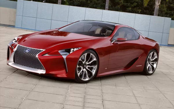 Red Lexus LF-LC concept vehicle parked on a tiled plaza, shot as an HD PC desktop wallpaper and background, showcasing sleek coupe lines, chrome grille and large alloy wheels.