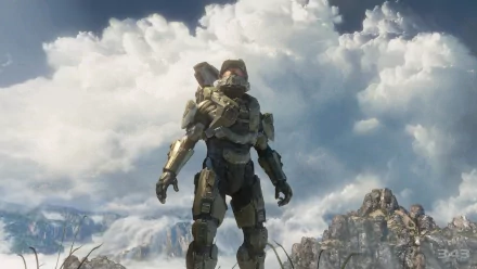 HD desktop wallpaper featuring Master Chief from Halo 4, standing against a dramatic cloudy sky with rocky terrain in the background.