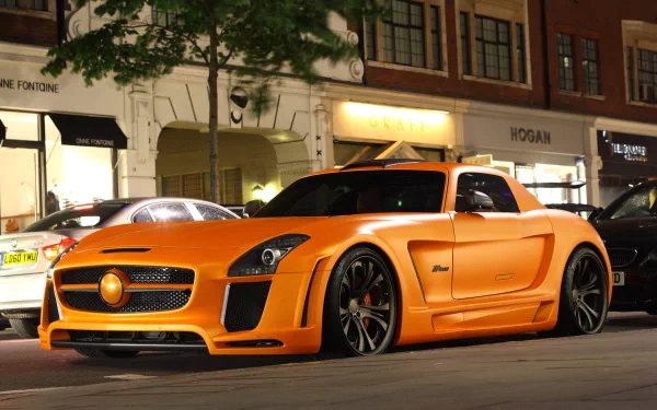 A striking orange Mercedes vehicle parked on an urban street, set against a softly lit backdrop, making for an impressive HD PC desktop wallpaper and background.