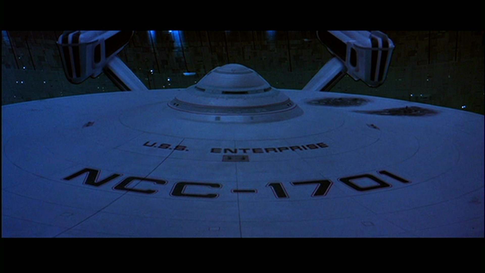 A striking HD wallpaper featuring the U.S.S. Enterprise from Star Trek III: The Search for Spock, showcasing its iconic design against a dark cosmic backdrop.