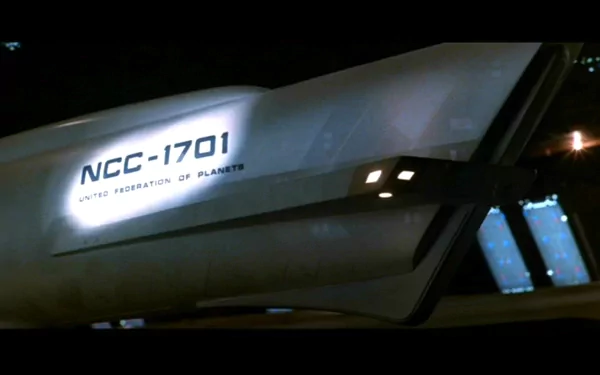 Close-up of the USS Enterprise NCC-1701 hull with lit windows against a dark space backdrop — movie: Star Trek II: The Wrath of Khan. HD PC desktop wallpaper / background.