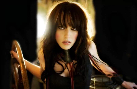 HD desktop wallpaper showing singer Lzzy Hale with dark hair and intense gaze in a moody, music-inspired setting.