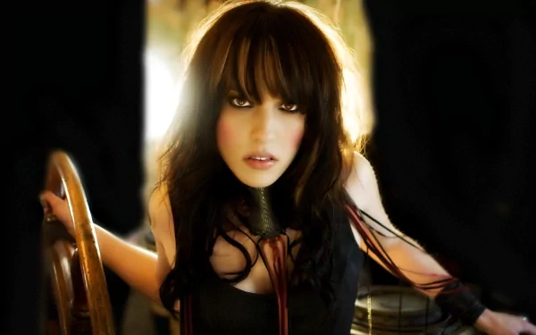HD desktop wallpaper showing singer Lzzy Hale with dark hair and intense gaze in a moody, music-inspired setting.