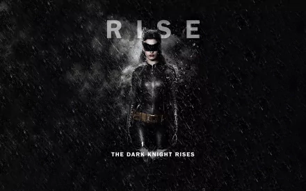 HD desktop wallpaper: Catwoman / Selina Kyle from The Dark Knight Rises in a black suit and mask, standing in rain beneath the word RISE with the film title below.