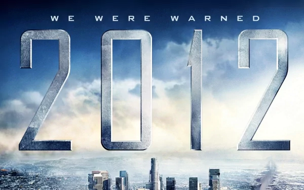 A dramatic HD wallpaper featuring the movie 2012, showcasing the tagline We Were Warned against a backdrop of a turbulent sky and city skyline.
