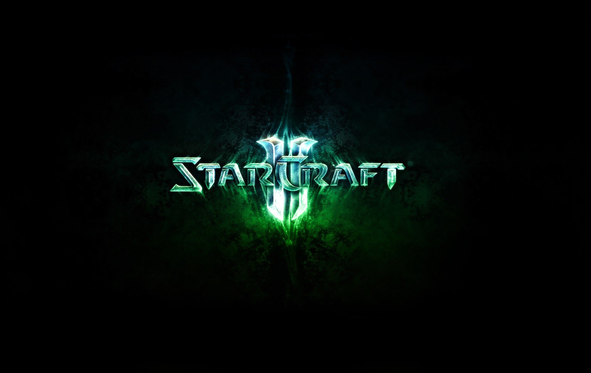 HD PC desktop wallpaper for the video game StarCraft II: logo glowing emerald green on a dark, smoky background.
