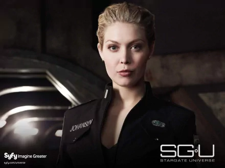 HD desktop wallpaper featuring Alaina Huffman as Tamara Johansen from the TV show Stargate Universe in a dark, sci-fi setting.